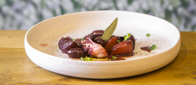 Octopus in red wine with ILIADA Organic Extra Virgin Olive Oil and fresh oregano