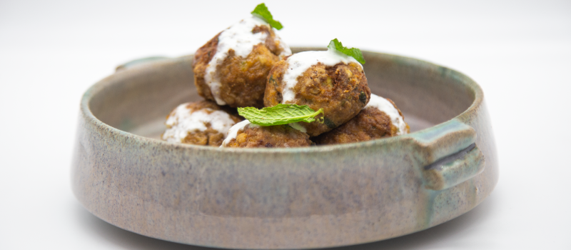 Zucchini balls with ILIADA Extra Virgin Olive Oil with Basil and yogurt dip